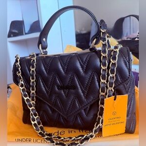 Valentino Handbag
Gorgeous quilted black handbag with gold chain accents
